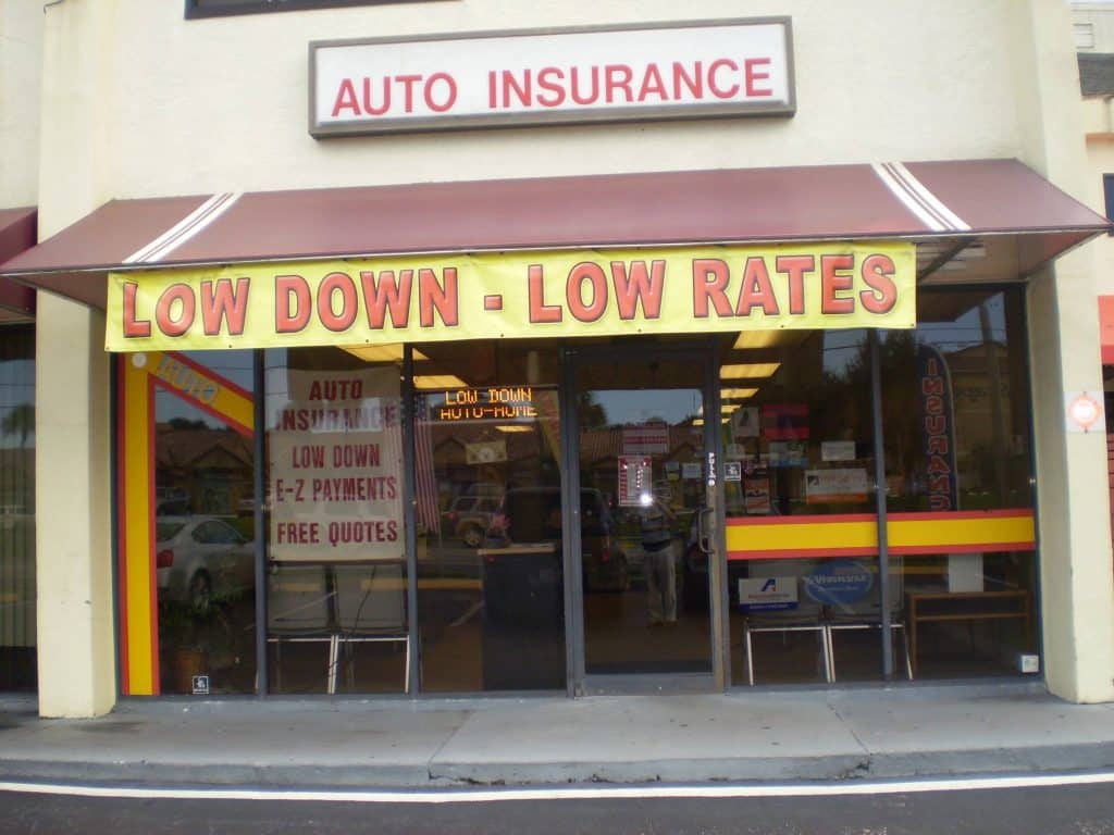 Banner outside our office showing the Colucci agency provides cheap FR44 insurance in Florida with Low Down & Low Rates